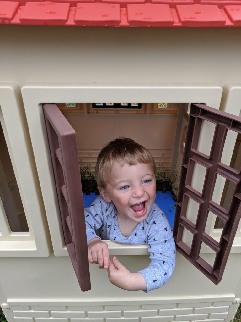 toddler in Little Tikes playhouse