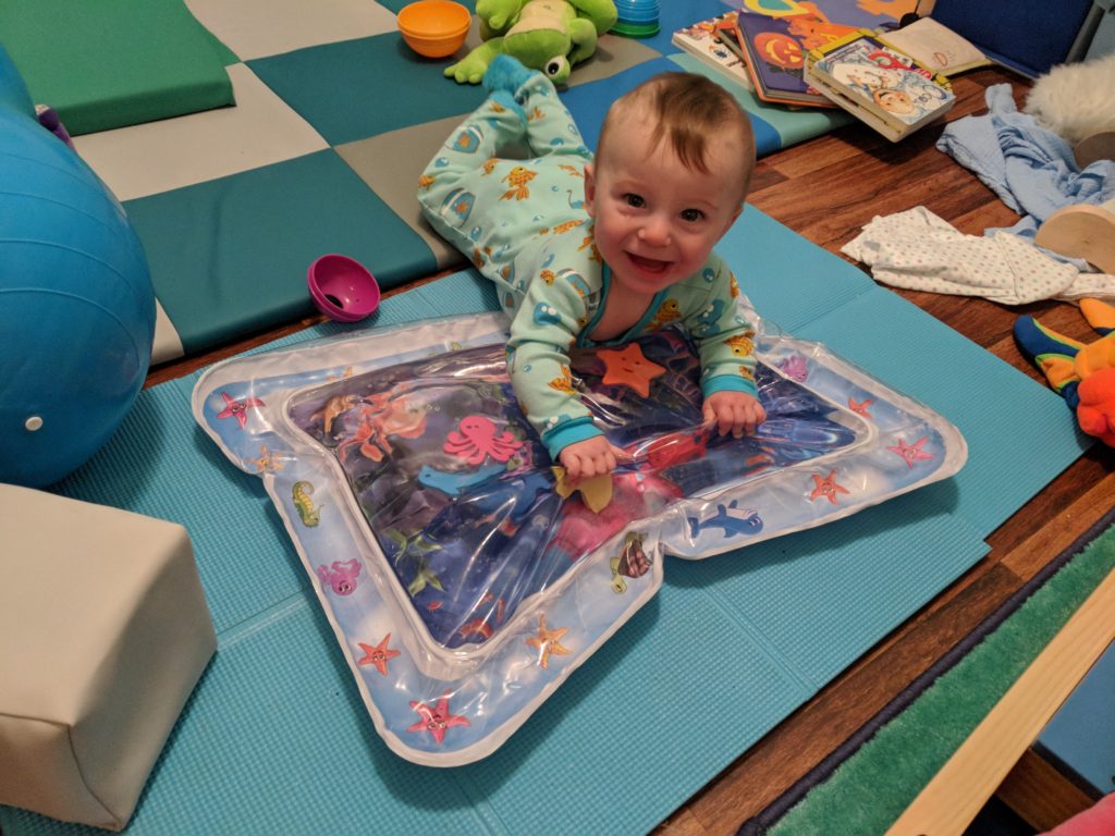 baby doing tummy time on inflatable water mat