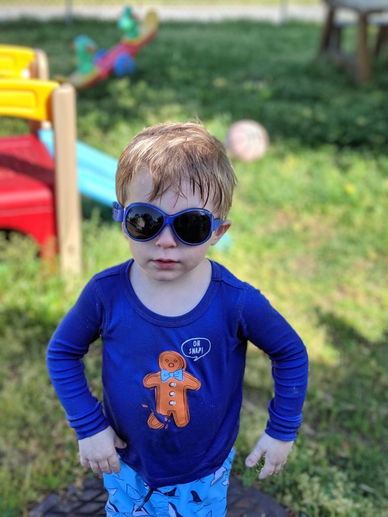 proud toddler wearing Baby BANZ sunglasses