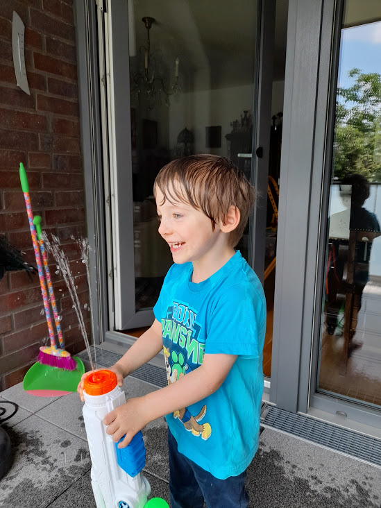 toddler shooting with X Shot Hydro Hurricane water gun