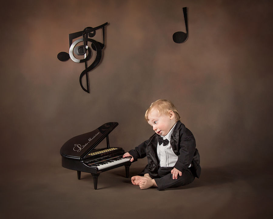 one-year-old boy playing toy piano